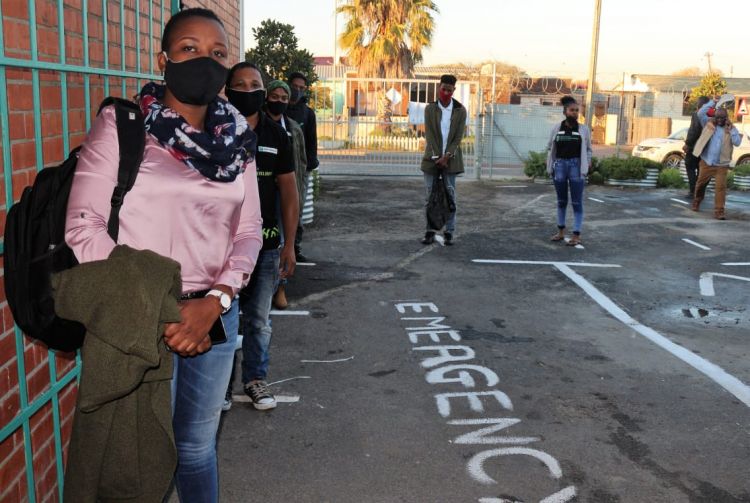 Youth practice safe distancing while waiting to enter the Community Learning Center