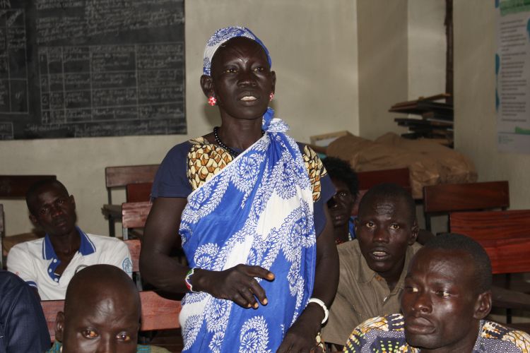 A woman speaking up at the community dialogue