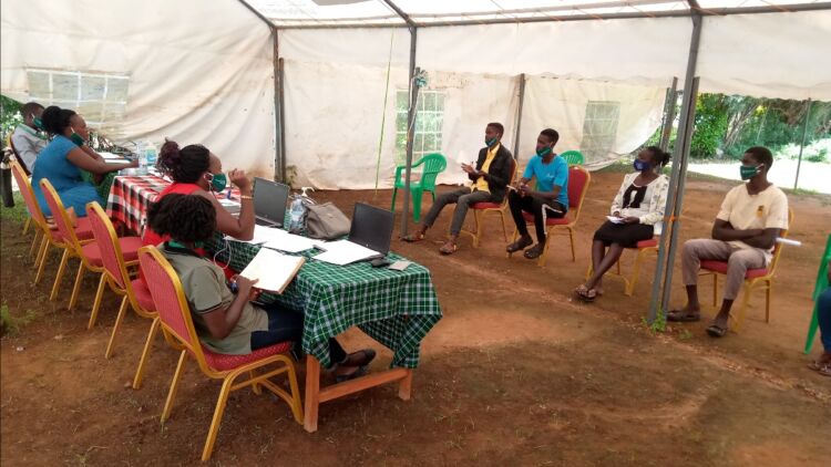 A Panel of WPDI youth listen to a pitch in the Business Plan Competition in Uganda