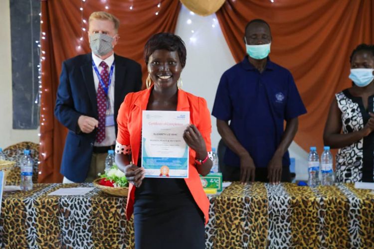 A youth women graduating from a peace and security training by WPDI and UN Women