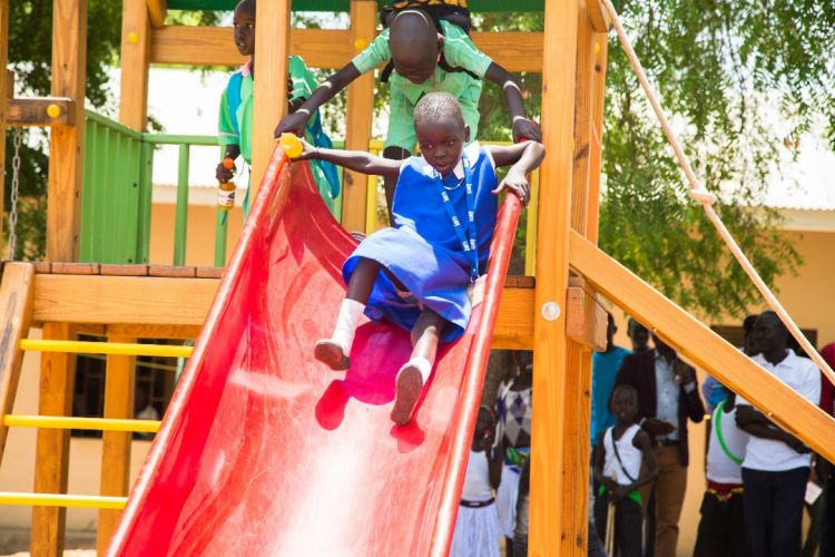 Child slides down new slide