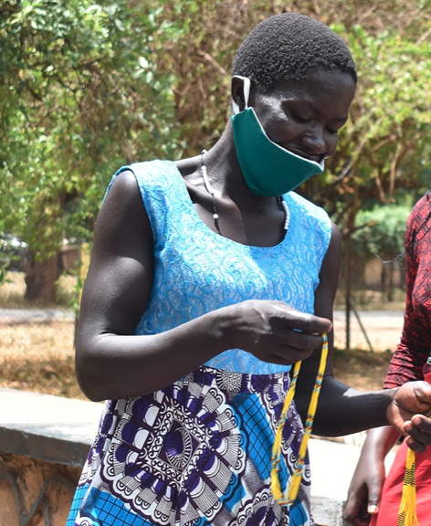 A WPDI youth and Arts and Crafts trainee showing what they made to the community